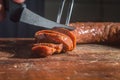 Sliced Ã¢â¬â¹Ã¢â¬â¹smoked calabrese sausage in a wooden table,copy space